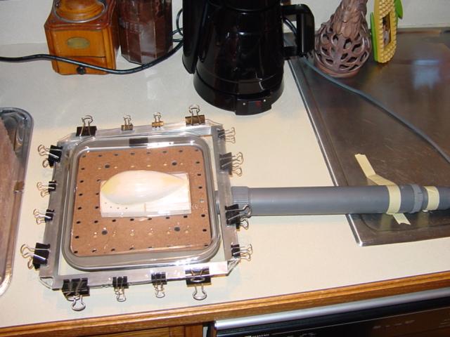 vacuum bed with mold and vacuum source attached